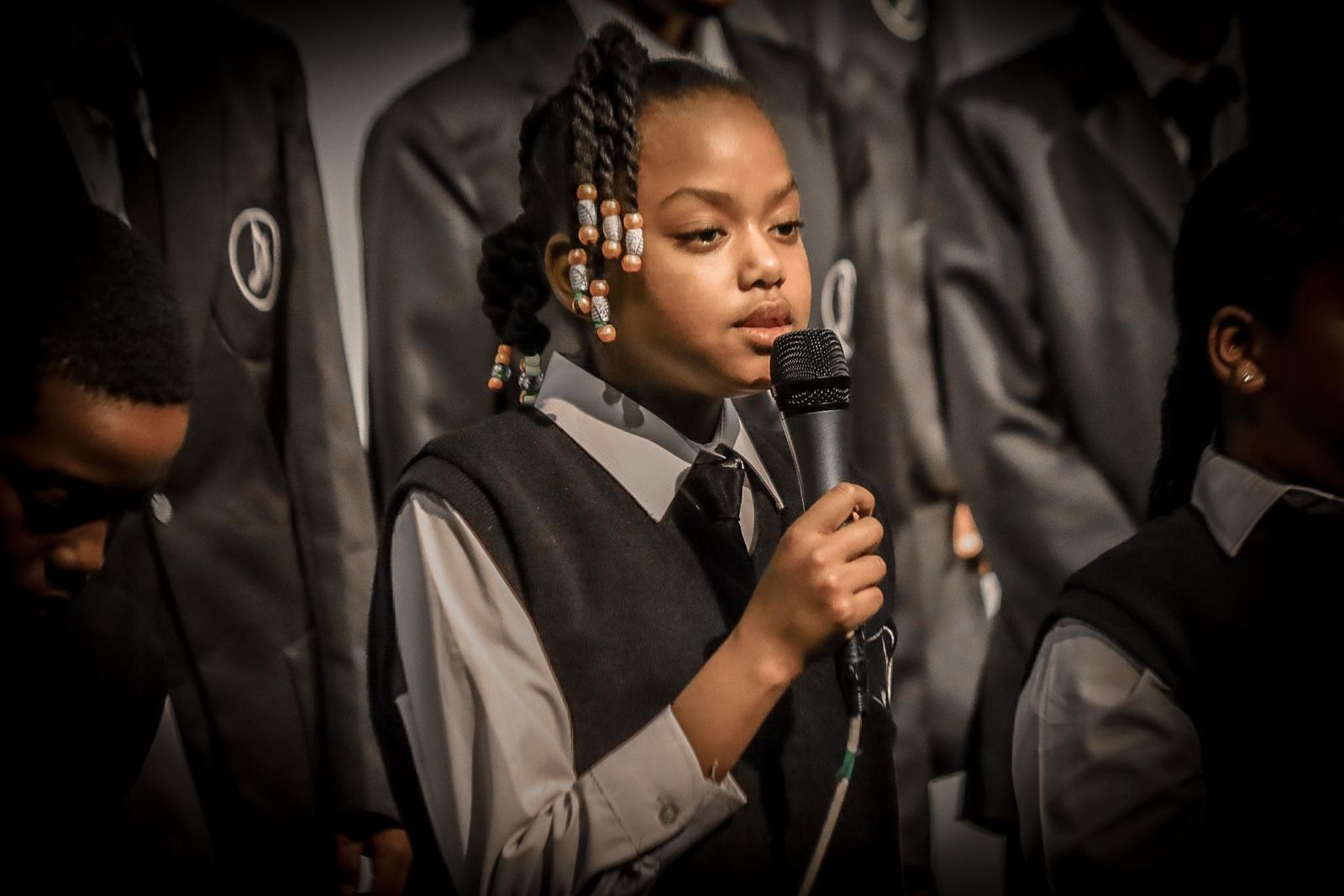 Student soloist singing into a microphone