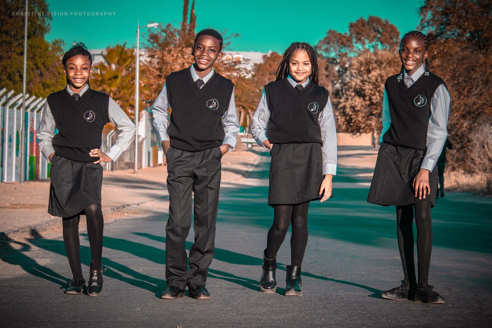 Students in uniform posing on a street